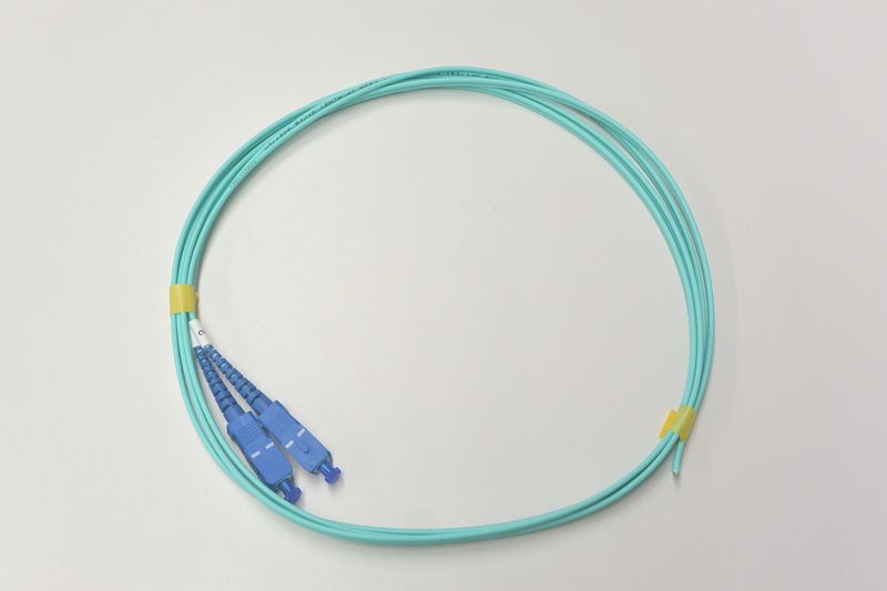 10G光パッチコード GI50 OM3 2芯メガネ 片端SC 2m アクア